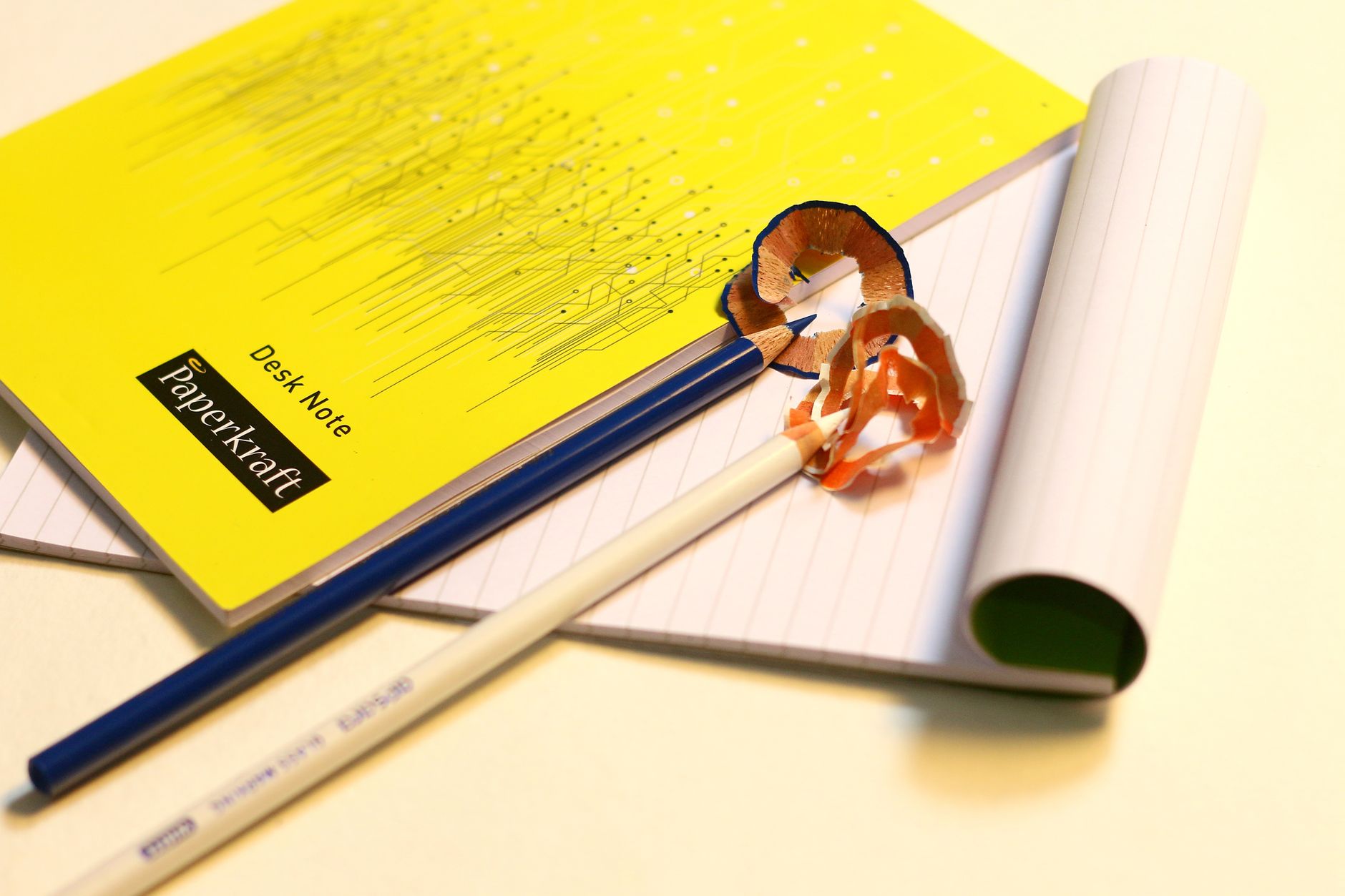 Vibrant stationery set featuring sharpened pencils and labeled notebooks on a desk.